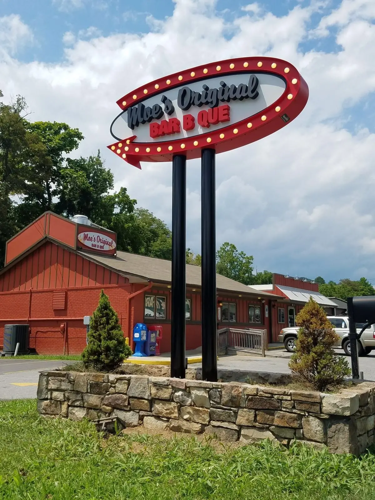Illuminated oval pylon sign for Moe's Original Bar B Que