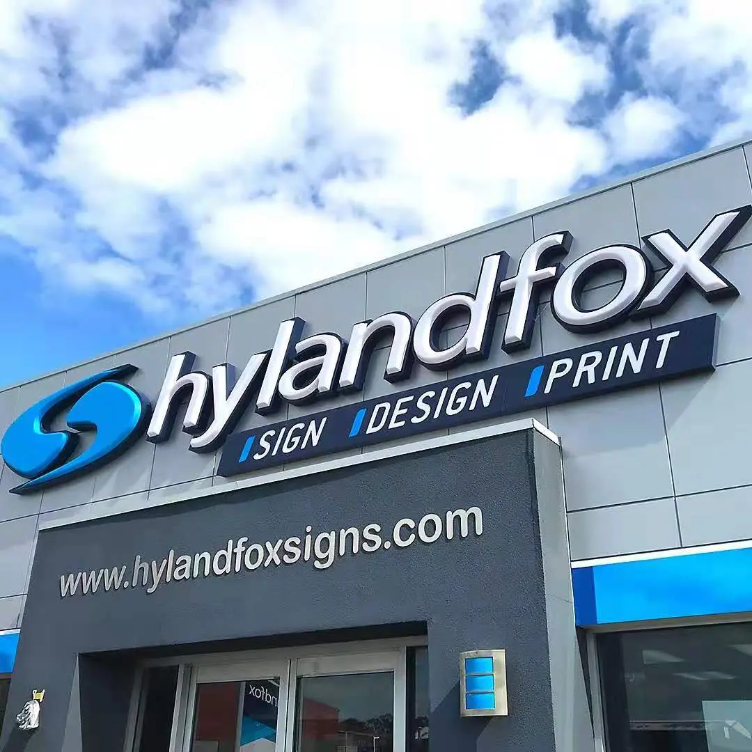 Fachada de una empresa de letreros, diseño e impresión con letras termoformadas blancas y logotipo azul